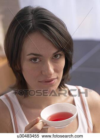 Stock Photography - Woman holding a cup of tea. Fotosearch