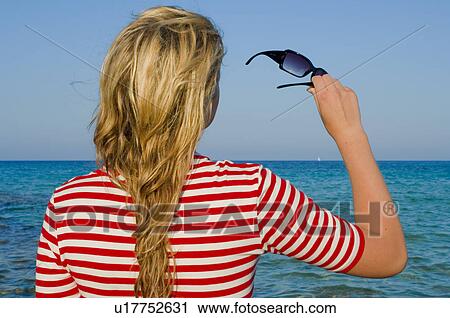 Woman holding sunglasses View Large Photo Image Stock Image - Woman holding sunglasses. Fotosearch