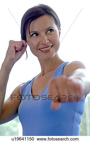 Stock Image - Woman in sportswear doing aerobic exercises. Fotosearch