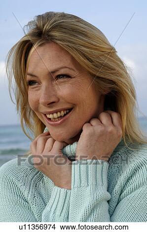 Woman in turquoise pullover at the sea View Large Photo Image Picture - Woman in turquoise pullover at the sea. Fotosearch