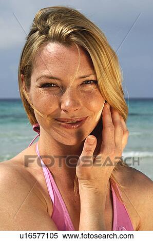 Woman is applying sunlotion View Large Photo Image Stock Photography - Woman is applying sunlotion. Fotosearch