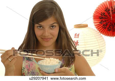 Woman is eating rice with chopsticks View Large Photo Image Stock Image - Woman is eating rice with chopsticks. Fotosearch