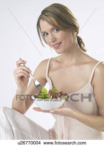 Woman is eating salad View Large Photo Image Picture - Woman is eating salad. Fotosearch