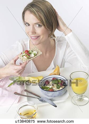 Woman is having breakfast with crispbread and cereals View Large Photo Image Stock Photography - Woman is having breakfast with crispbread and cereals. Fotosearch
