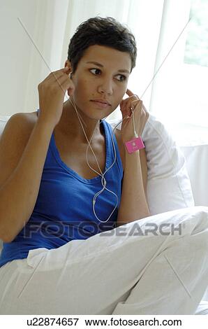 Stock Photo - Woman listening to music. Fotosearch