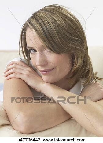 Woman lounging on a sofa View Large Photo Image Stock Image - Woman lounging on a sofa. Fotosearch