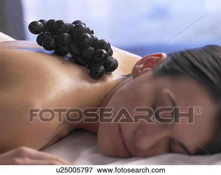 Stock Photo - Woman lying on a massage table. Fotosearch