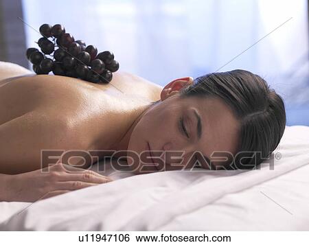 Stock Photograph - Woman lying on a massage table. Fotosearch