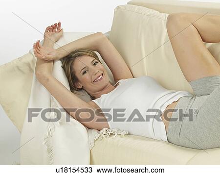 Stock Image - Woman lying on a sofa. Fotosearch