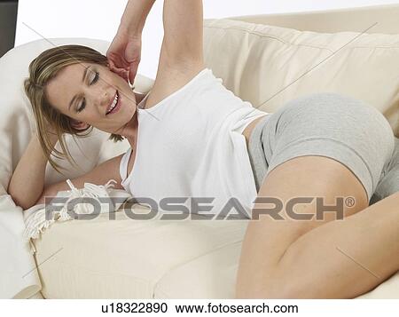 Woman lying on a sofa View Large Photo Image Stock Image - Woman lying on a sofa. Fotosearch