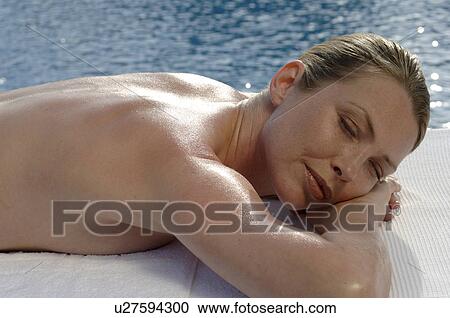 Woman lying on the massagebed at the sea View Large Photo Image Stock Image - Woman lying on the massagebed at the sea. Fotosearch