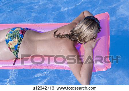 Stock Image - Woman on a airmattress. Fotosearch