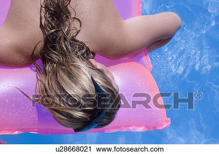 Stock Image - Woman on a airmattress. Fotosearch