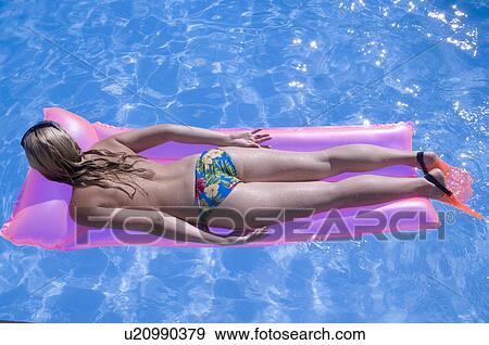 Stock Photo - Woman on a airmattress. Fotosearch