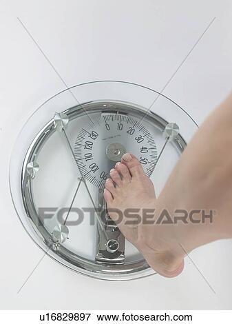 Woman on a bathroom scale, feet View Large Photo Image Stock Photo - Woman on a bathroom scale, feet. Fotosearch