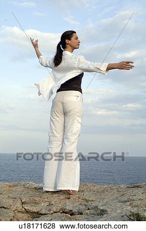 Woman on a rock at the sea View Large Photo Image Stock Photo - Woman on a rock at the sea. Fotosearch