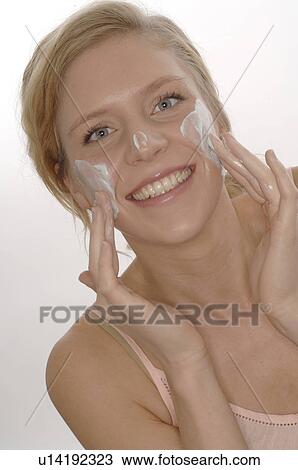 Woman putting on face cream View Large Photo Image Stock Image - Woman putting on face cream. Fotosearch