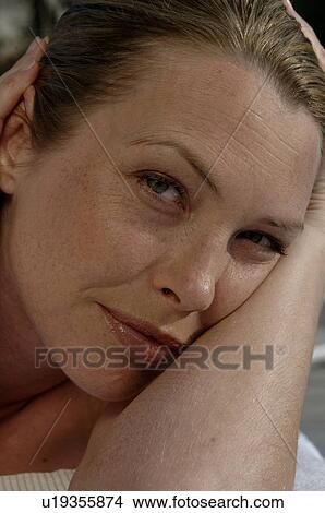 Picture - Woman rests head on her arm. Fotosearch
