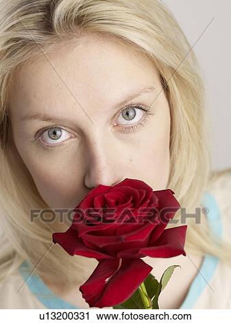 Woman smelling at rose View Large Photo Image Stock Image - Woman smelling at rose. Fotosearch