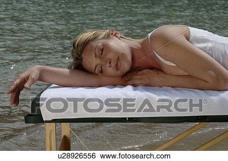 Woman sunbathes View Large Photo Image Stock Photograph - Woman sunbathes. Fotosearch