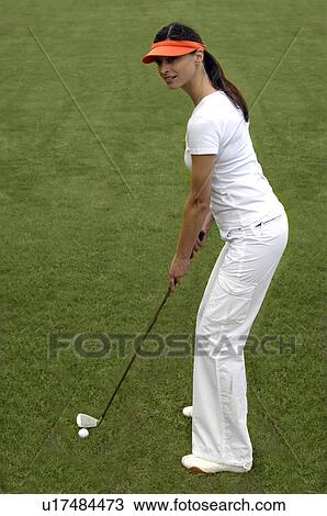 Woman tees off View Large Photo Image Stock Image - Woman tees off. Fotosearch