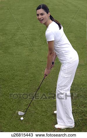 Stock Image - Woman tees off. Fotosearch