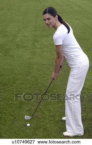 Stock Photo - Woman tees off. Fotosearch