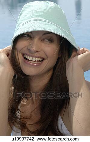 Stock Image - Woman wearing a sun hat. Fotosearch