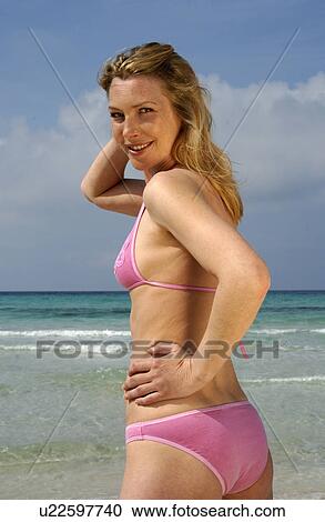 Woman wearing bikini on the beach View Large Photo Image Stock Image - Woman wearing bikini on the beach. Fotosearch