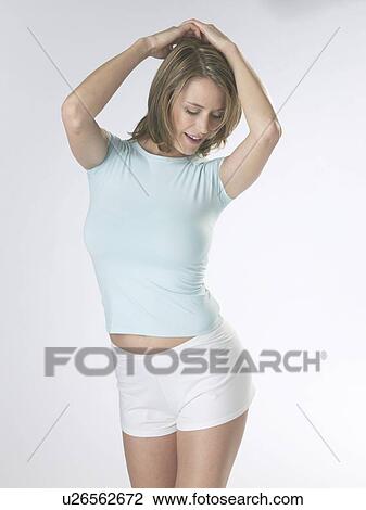 Woman wearing white shorts and a t-shirt View Large Photo Image Stock Image - Woman wearing white shorts and a t-shirt. Fotosearch