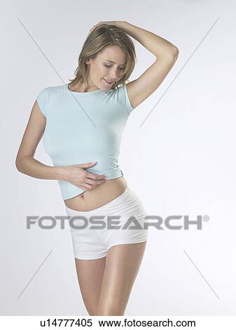 Stock Photography - Woman wearing white shorts and a t-shirt. Fotosearch