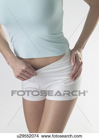 Picture - Woman wearing white shorts. Fotosearch
