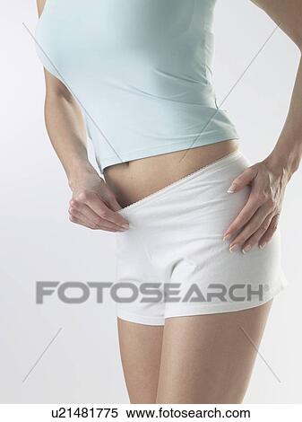 Stock Photography - Woman wearing white shorts. Fotosearch