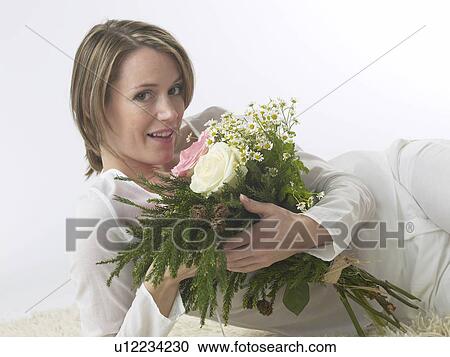 Woman with a bouquet View Large Photo Image Stock Image - Woman with a bouquet. Fotosearch