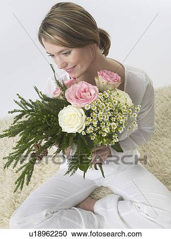 Woman with a bouquet View Large Photo Image Stock Image - Woman with a bouquet. Fotosearch