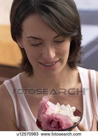 Stock Image - Woman with a bowl filled blossoms. Fotosearch