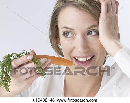 Stock Photo - Woman with a carrot. Fotosearch