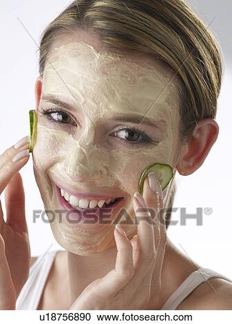 Woman with a cucumber mask View Large Photo Image Stock Image - Woman with a cucumber mask. Fotosearch