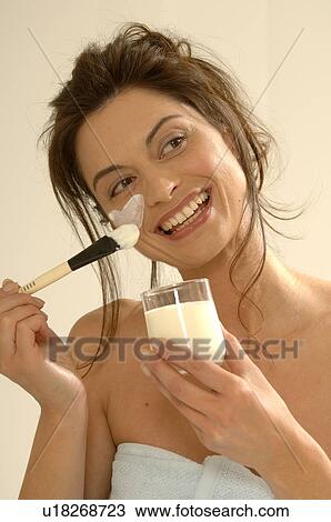 Stock Image - Woman with a facial mask. Fotosearch