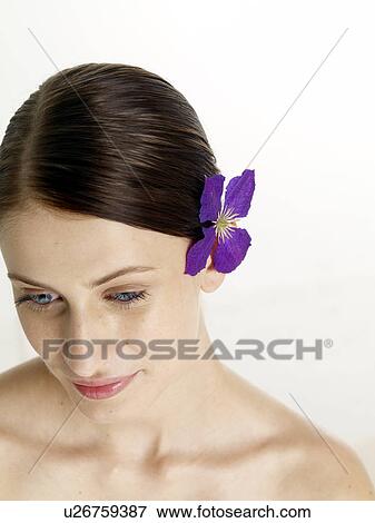 Stock Photo - Woman with a lilac blossom in her hair. Fotosearch