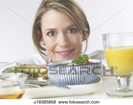 Stock Photo - Woman with brakfast table. Fotosearch