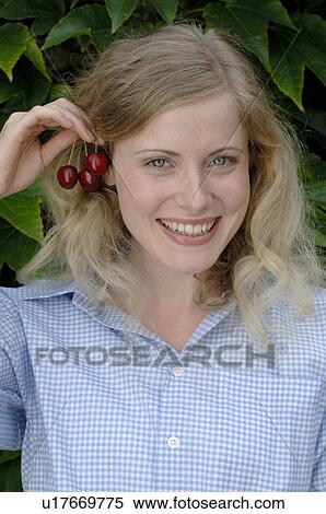 Stock Photography - Woman with cherry earrings. Fotosearch