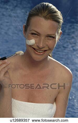 Stock Photo - Woman with facial mask and brush. Fotosearch