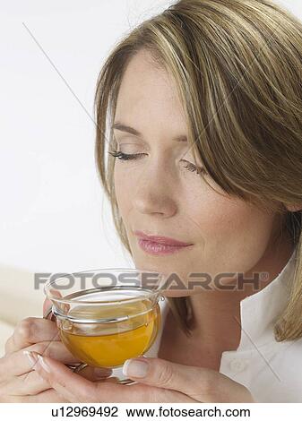 Woman with glass tea cup View Large Photo Image Stock Image - Woman with glass tea cup. Fotosearch