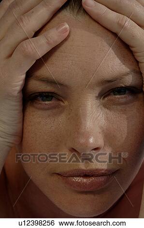 Woman with hands at her temples View Large Photo Image Stock Photograph - Woman with hands at her temples. Fotosearch