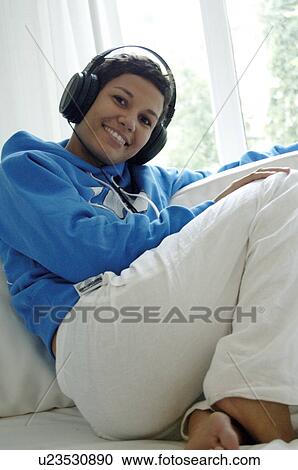 Stock Image - Woman with headphones. Fotosearch