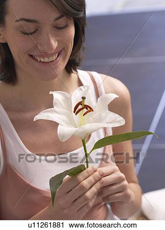 Stock Image - Woman with lily blossom. Fotosearch