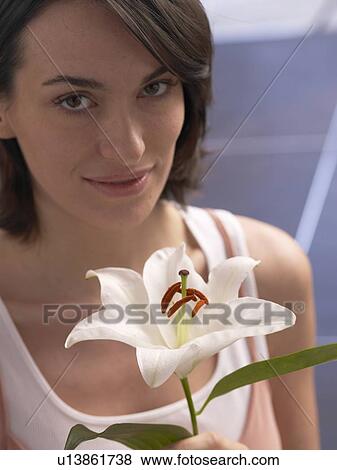 Stock Photo - Woman with lily blossom. Fotosearch