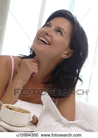 Stock Image - Woman with muesli for breakfast. Fotosearch