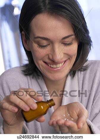 Picture - Woman with pills. Fotosearch